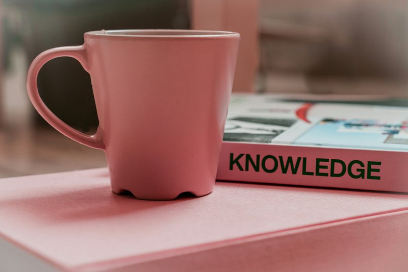 Mug with book representing women's health and knowledge application