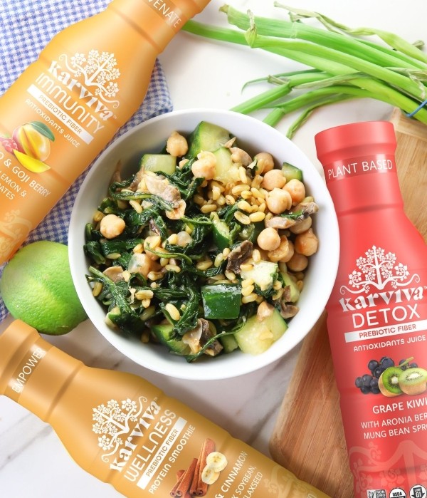 Healthy meal bowl with chickpeas and greens paired with Karviva Immunity, Wellness, and Detox drinks.