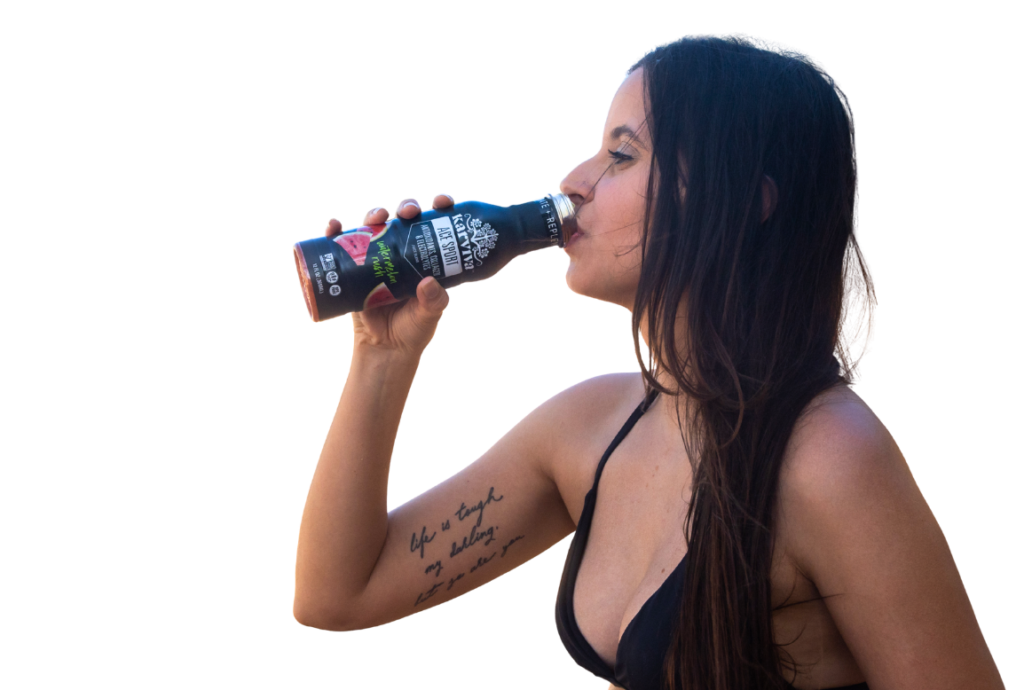 Woman drinking bottled beverage outdoors