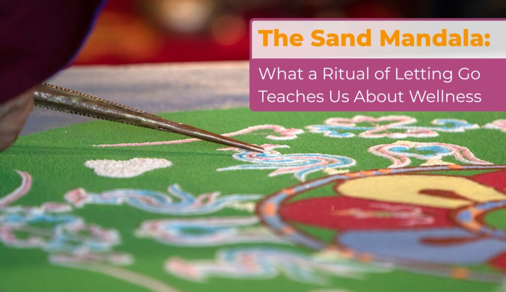 Monk creating colorful sand mandala with metal tool