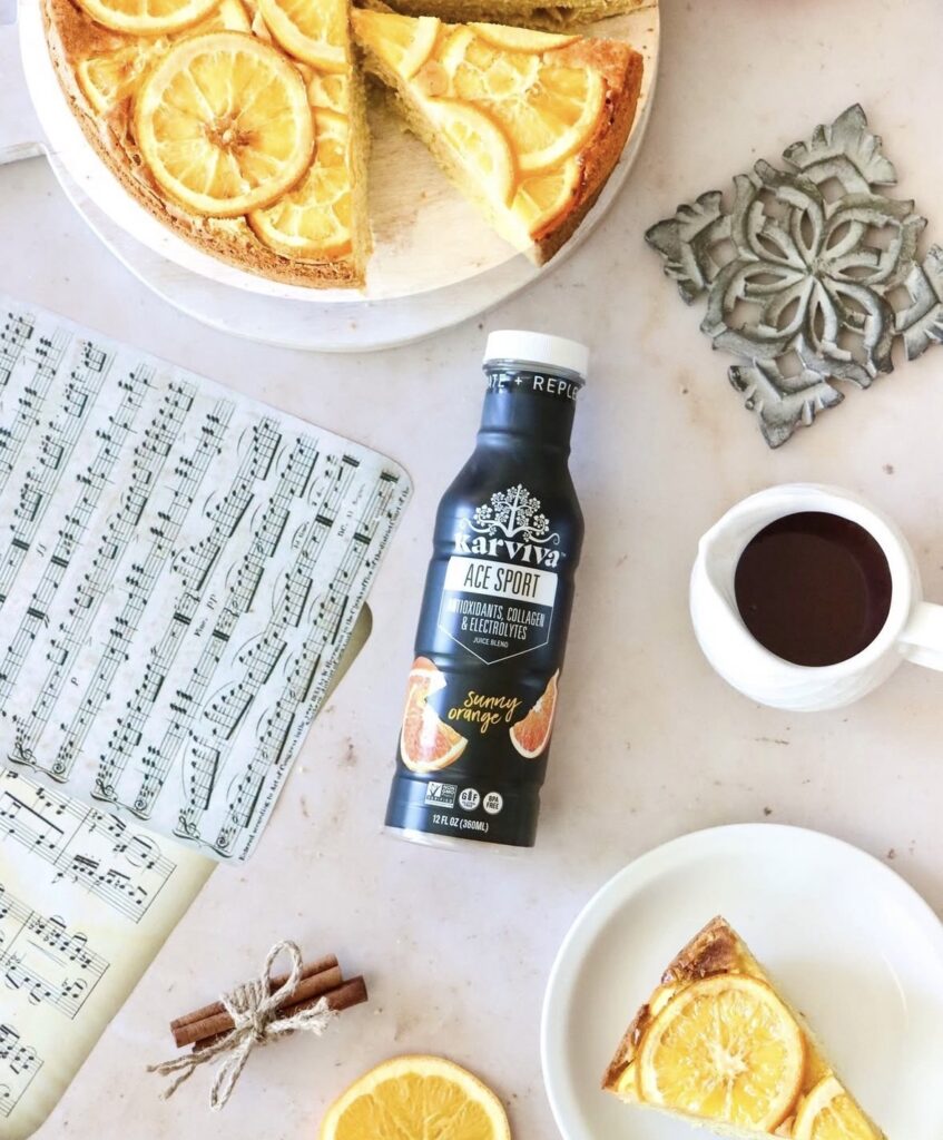 Orange cake, coffee, and Karviva sports drink flat lay