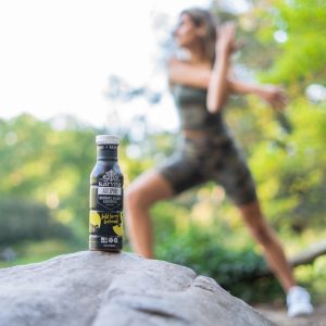 ACE Sport drink bottle on rock outdoors